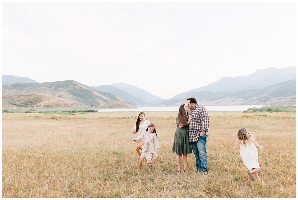 Young family in open golden field in Midway, Utah