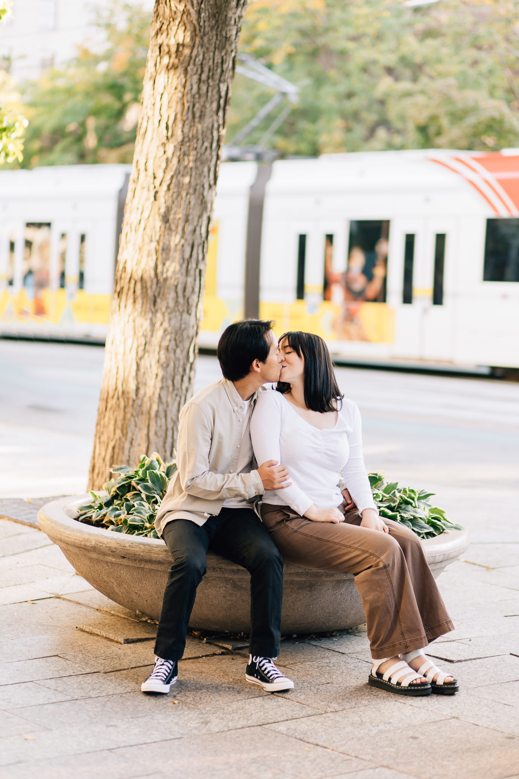 Engagement Photographer Kailee Matsumura Photography captures soon to be married couple kissing by the frontrunner. city engagements #KaileeMatsumuraPhotography #KailleMatsumuraEngagements #SLCengagement #Utahphotographers #engagementphotography