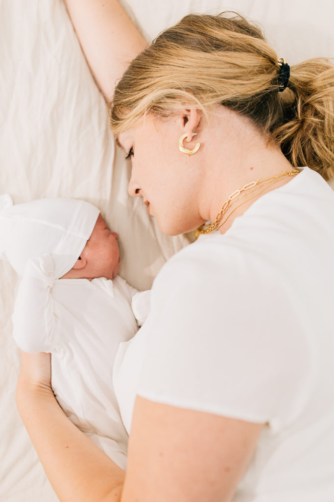Kailee Matsumura Photography captures a precious moment of motherhood with a newborn baby and mother. mother moment photography #KaileeMatsumuraPhotography #SLCphotographers #motherhood #newbornphotography #Utahfamilyphotography #babyportraits