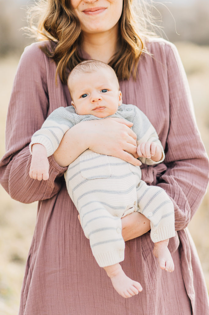 UT newborn photographer captures a baby boy held in his mothers arms by Kailee Matsumura Photography. baby boy SLC family photos #KaileeMatsumuraPhotography #SLCphotographers #motherhood #newbornphotography #Utahfamilyphotography #babyportraits