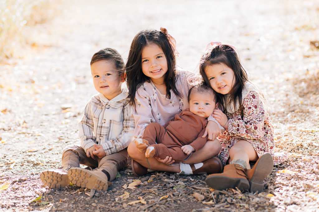 Four little siblings with their new baby brother captured by Kailee Matsumura a family photographer. little kid siblings #KaileeMatsumuraPhotography #SLCphotographers #motherhood #newbornphotography #Utahfamilyphotography #babyportraits