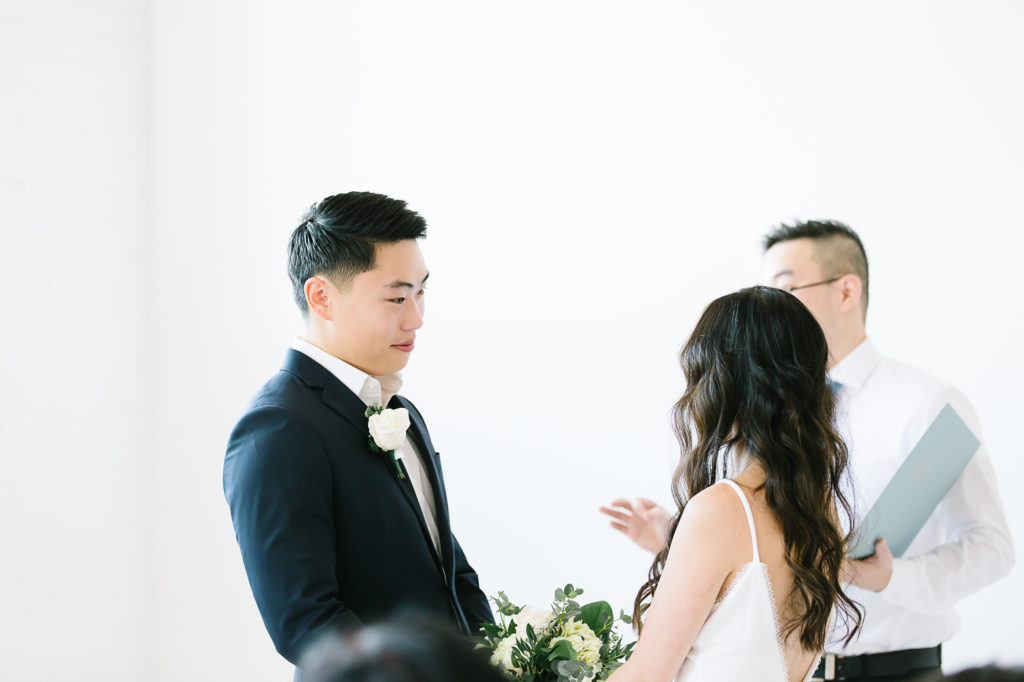 Groom looking lovingly at his bride during the ceremony. #KaileeMatsumuraPhotography #KaileeMatsumuraWeddings #Studiowedding #UtahWedding #SLCwedding #SLCweddingphotographer
#WeddingphotographerinSLC