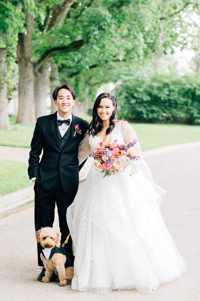 Kailee Matsumura Photography captures the bride and groom with their tiny dog dressed in a tux. dogs in weddings fur baby in weddings dog in a tux for wedding #KaileeMatsumuraPhotography #Bartlett,TN #MemphisPhotography #KaileeMastumuraWeddings #TNweddingphotography #summerwedding #colorfulwedding