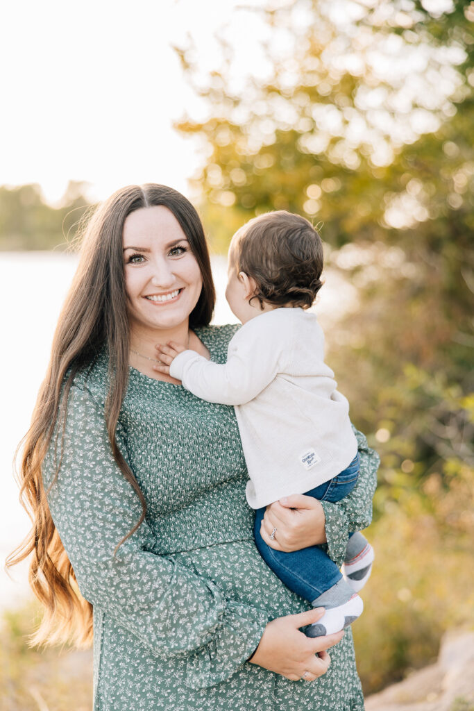 Mother holds her baby son in a gorgeous flowy dress in a blog post about dresses for family photo outfit inspiration by Kailee Matsumura professional family photographer in Memphis #familyphotos #familyoutfitinspo #tennesseephotographer