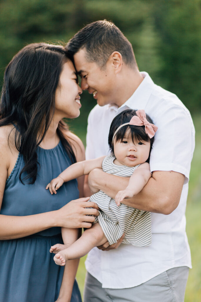 The sweetest couple lean their heads on close together during a Kailee Matsumura Photography session. The couple’s young daughter looks at the camera with a sweet smile.
#KaileeMatsumuraPhotography #MemphisFamilyPhotographer #TennesseFamilyPhotos #​​BartlettFamilyPhotographer #OutfitTips
