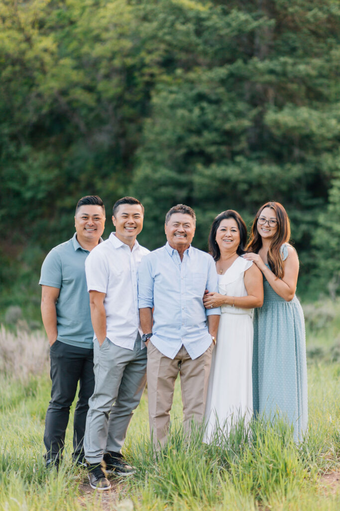 A family of five stand close together in front of a stunning tree background. This darling family was captured by Kailee Matsumura Photography, a Tennessee based photographer.
#KaileeMatsumuraPhotography #MemphisFamilyPhotographer #TennesseFamilyPhotos #​​BartlettFamilyPhotographer #OutfitTips