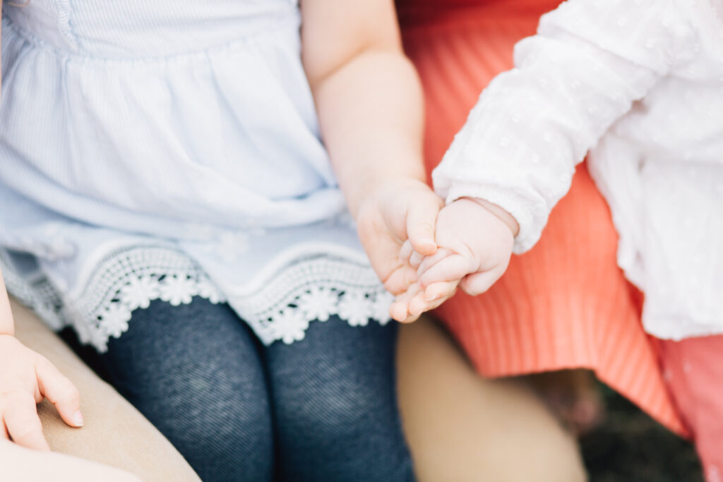 A close up image of two young sisters holding hands. Kailee Matsumura Photography, a Tennessee based family photographer, captures candid moments that last a lifetime.
#KaileeMatsumuraPhotography #MeaningfulFamilyPhotoSessions #TennesseeFamilyPhotographer
