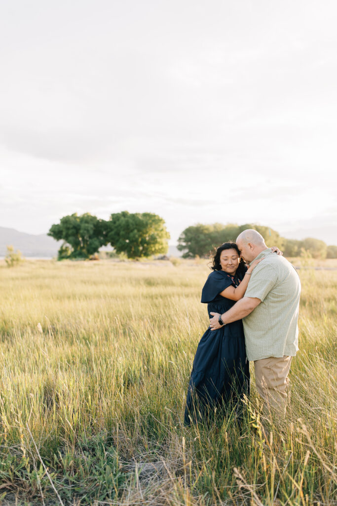 A darling couple stand wrapped up in each other’s arms. The value of having regular photos taken of your family at each new phase of life cannot be overstated as shared by Kailee Matsumura Photography. 
#KaileeMatsumuraPhotography #MemphisFamilyPhotographer #ReasonsToTakeFamilyPictures

