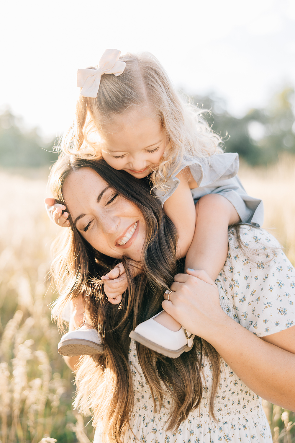 Mother and daughter's relationship in beautiful filtered light and coordinating outfits for a picture-perfect moment and family photo win. Love relationship motherhood outdoors playful hug #outdoorfamilyphotography #Tennessefamilyphotographer #mississippifamilyphotographer #tipsforsummerfamilyphotos
