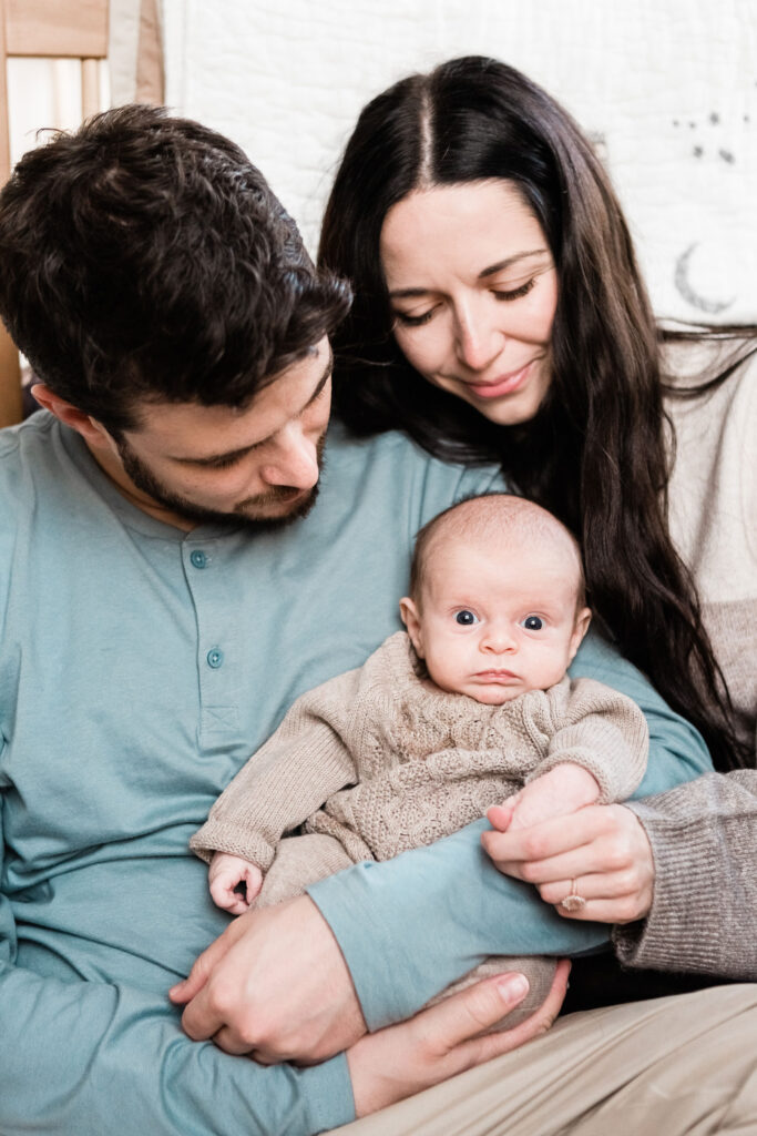 A newborn is held close by his parents while Kailee Matsumura, a Tennessee family photographer, captures the moment. pet family photography Olive Branch Mississippi #familypetphotography #tennesseenewbornphotographer #kaileematsumuraphotography #petsofinstagram