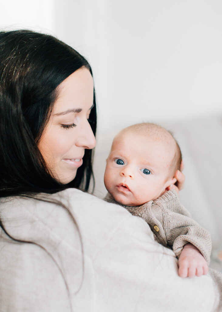 Memphis Newborn Photographer, Kailee Matsumura takes newborn photos in Memphis, Tennessee and Germantown, Tennessee. Newborn boy looks at the camera as his mom looks at him. 