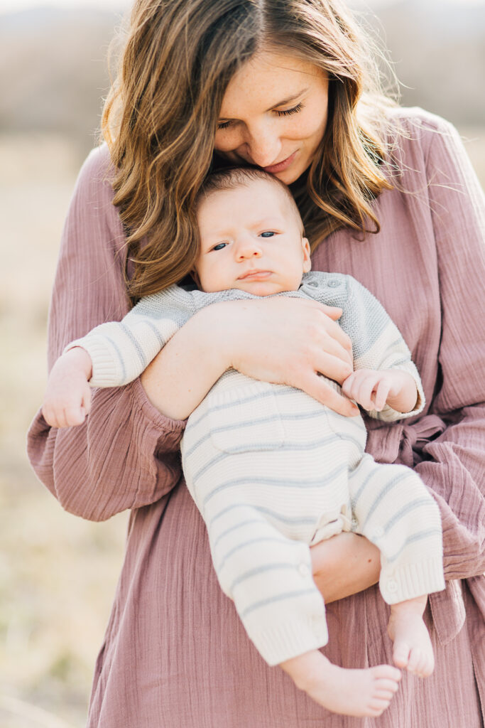 Mom holds her big newborn during a newborn session by Kailee Matsumura Photography, a Memphis Newborn Photographer. 