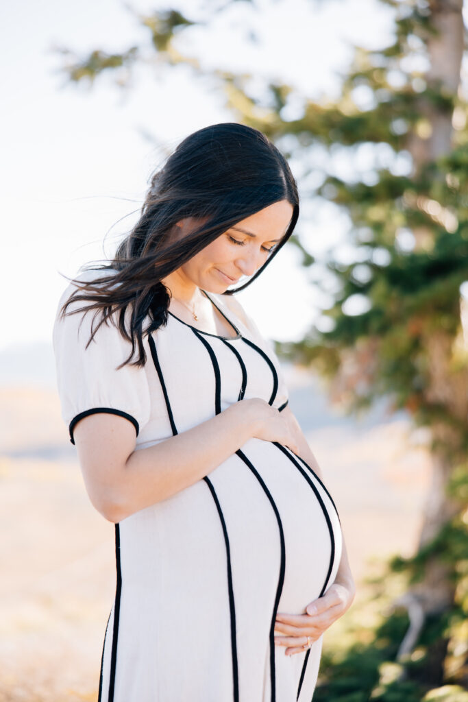 Momma looking down at her belly during her Memphis Maternity Session. 