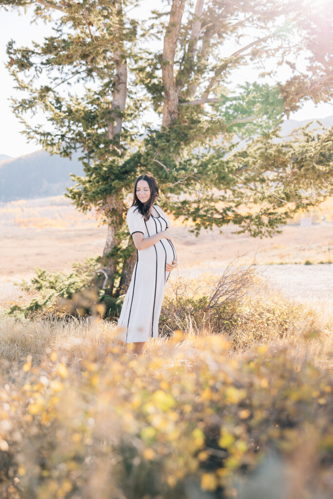 Motherhood Maternity session during the fall. Mother wearing a cream dress. Simple, neutral colors for a maternity session in Memphis. 