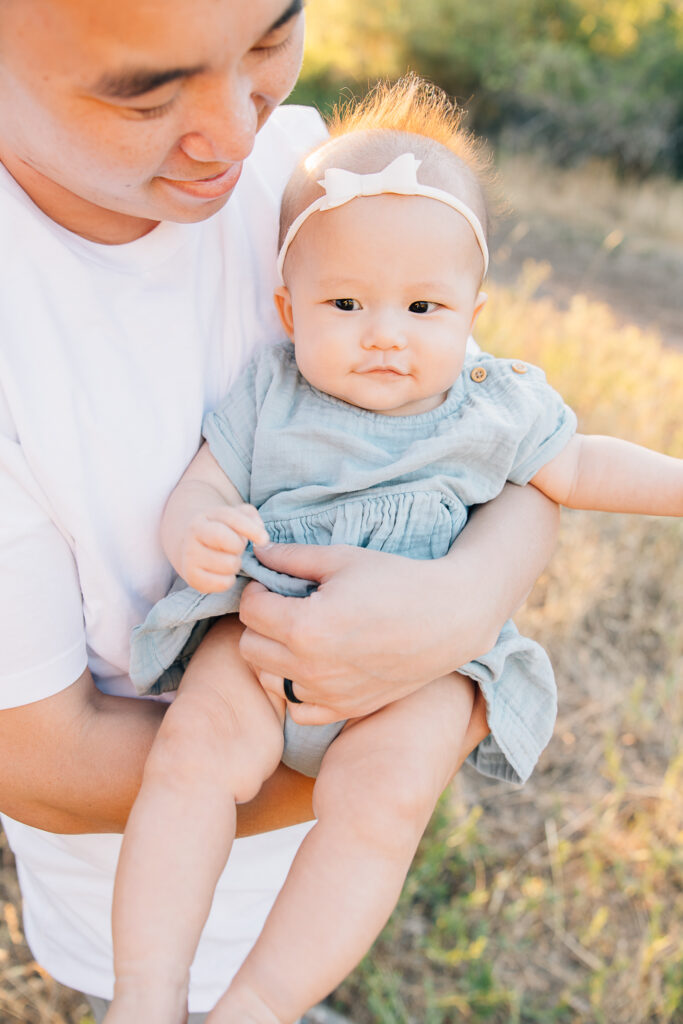 Dad snuggles with newborn daughter during his Germantown photo session at Shelby farms. Germantown Newborn Photographer. 