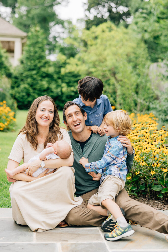 Family photo in backyard with yellow flowers. Salt Lake City. 
